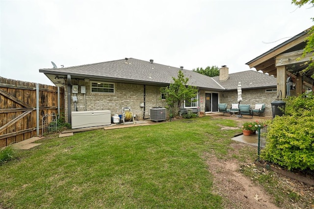 back of house with a patio, central AC, a yard, and fence