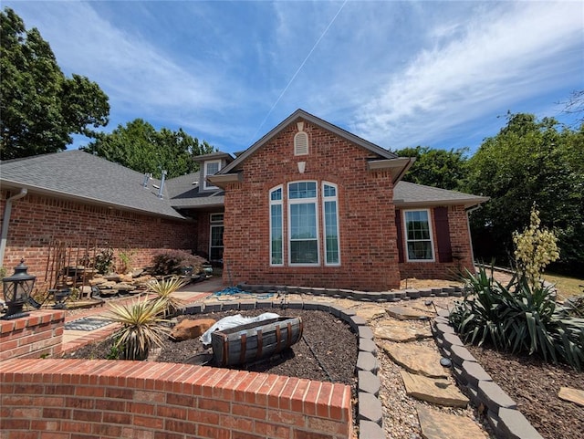 900 Walnut Pl, Norman, OK 73072 - rear view of property with brick siding, a shingled roof, and a patio area