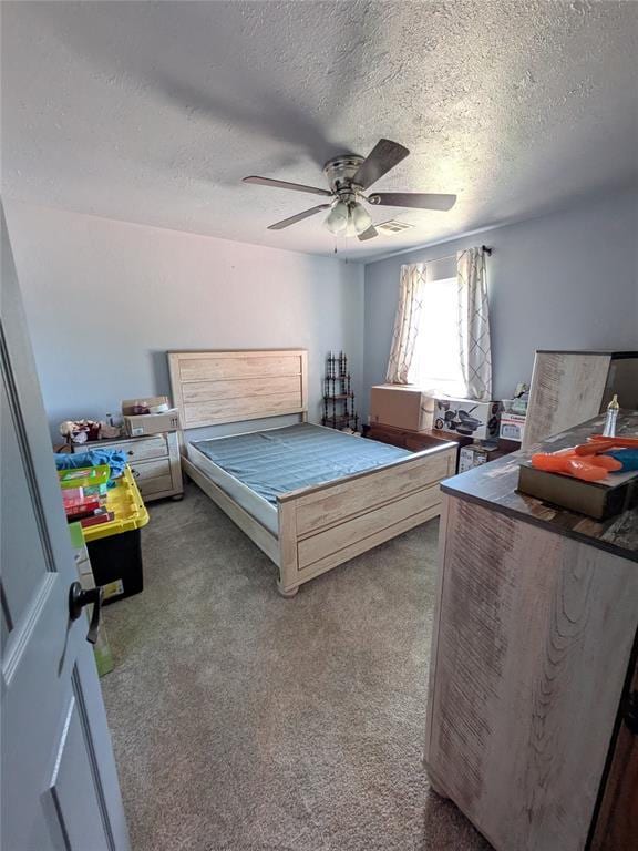 900 Walnut Pl, Norman, OK 73072 - carpeted bedroom featuring a textured ceiling and ceiling fan