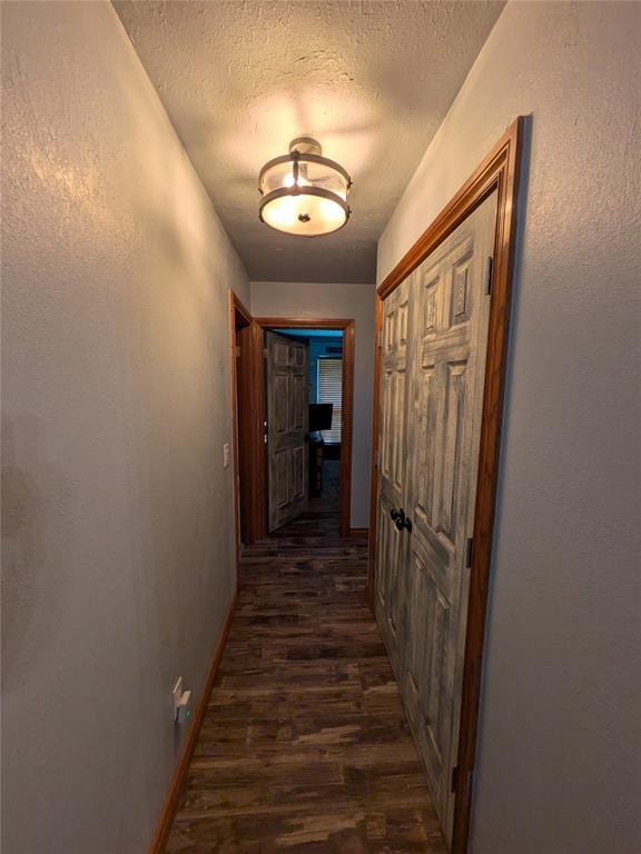 900 Walnut Pl, Norman, OK 73072 - hallway featuring a textured ceiling, dark wood-style floors, and baseboards