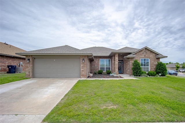 1208 Hickory Creek Dr, Yukon, OK 73099 - view of front of home with brick siding, driveway, a garage, a front lawn, and cooling unit