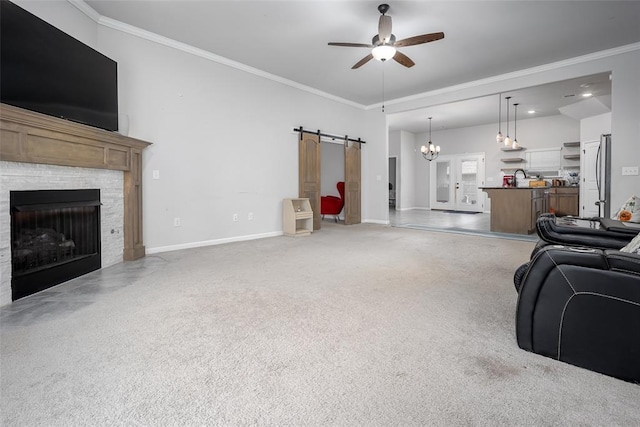 1208 Hickory Creek Dr, Yukon, OK 73099 - living room featuring light colored carpet, crown molding, a barn door, and ceiling fan