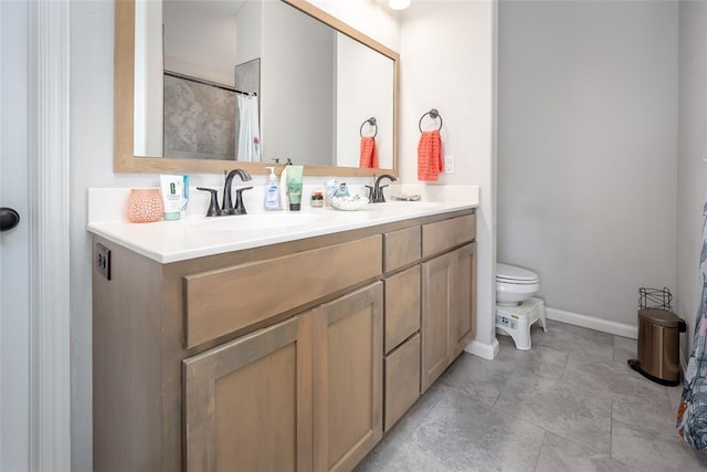 1208 Hickory Creek Dr, Yukon, OK 73099 - full bathroom featuring a sink, double vanity, toilet, and baseboards
