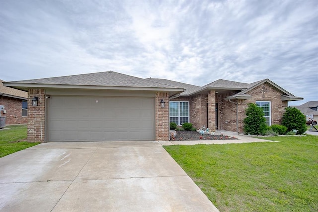 1208 Hickory Creek Dr, Yukon, OK 73099 - view of front of house featuring an attached garage, central AC unit, a front yard, brick siding, and driveway