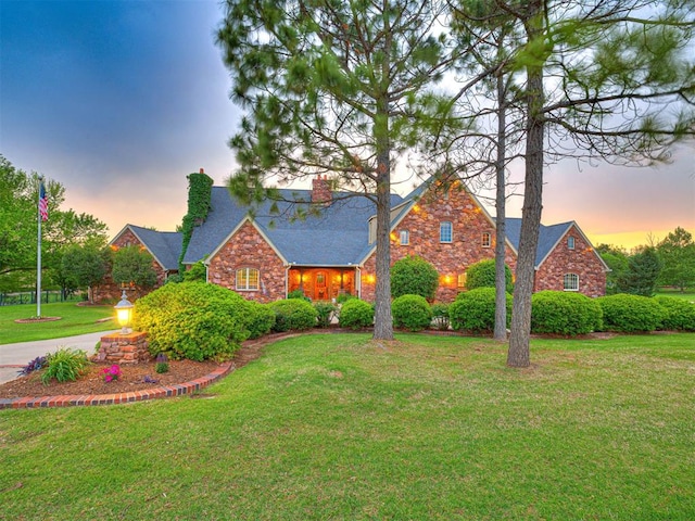 3812 Ridgeline Dr, Norman, OK 73072 - view of front facade featuring stone siding, a yard, and a chimney