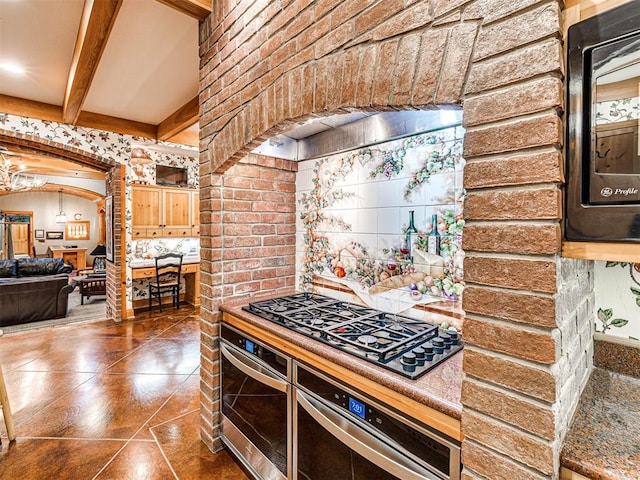 3812 Ridgeline Dr, Norman, OK 73072 - kitchen with beam ceiling, black appliances, and arched walkways
