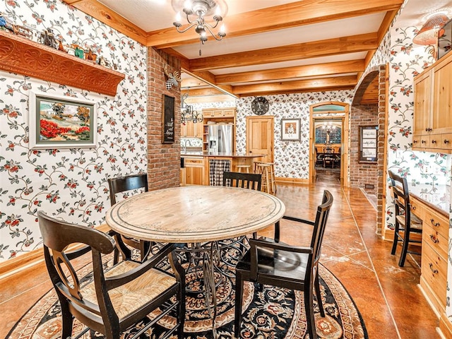 3812 Ridgeline Dr, Norman, OK 73072 - dining space featuring beam ceiling, arched walkways, light tile patterned floors, baseboards, and wallpapered walls