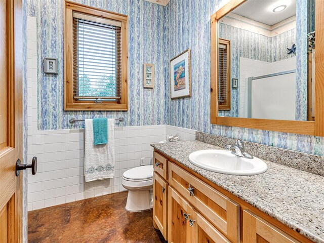 3812 Ridgeline Dr, Norman, OK 73072 - full bath with wallpapered walls, toilet, a shower stall, vanity, and a wainscoted wall