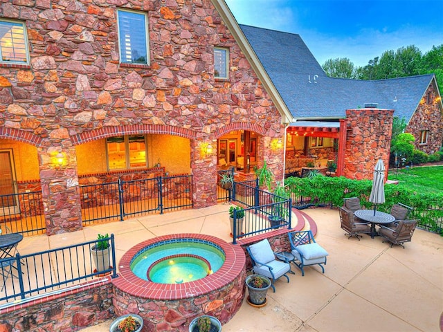 3812 Ridgeline Dr, Norman, OK 73072 - view of patio / terrace featuring an in ground hot tub and fence