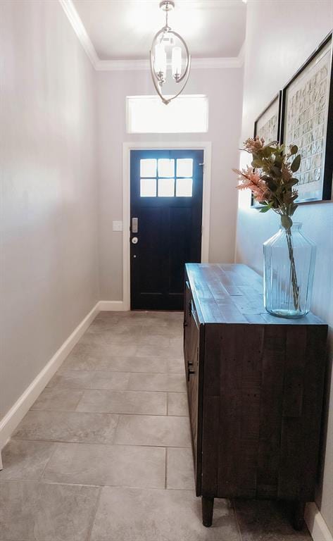 entrance foyer with baseboards and ornamental molding