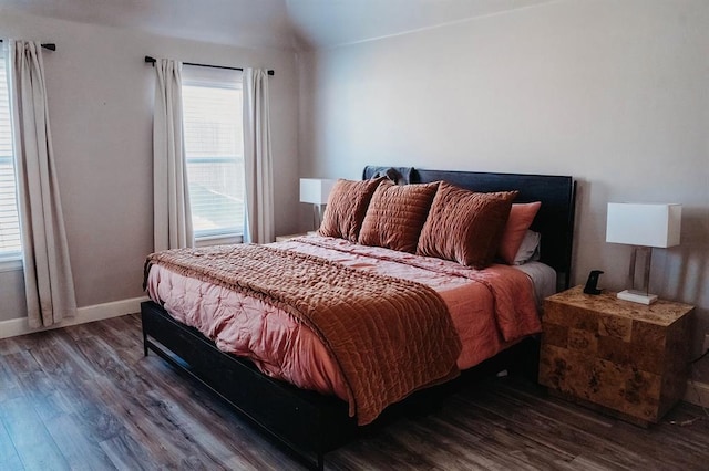 bedroom with baseboards and wood finished floors