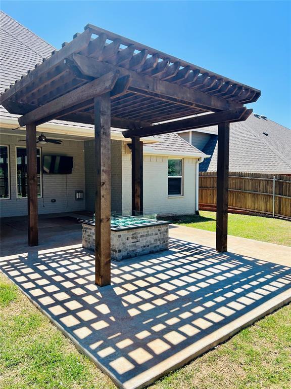 view of patio / terrace with a pergola and fence