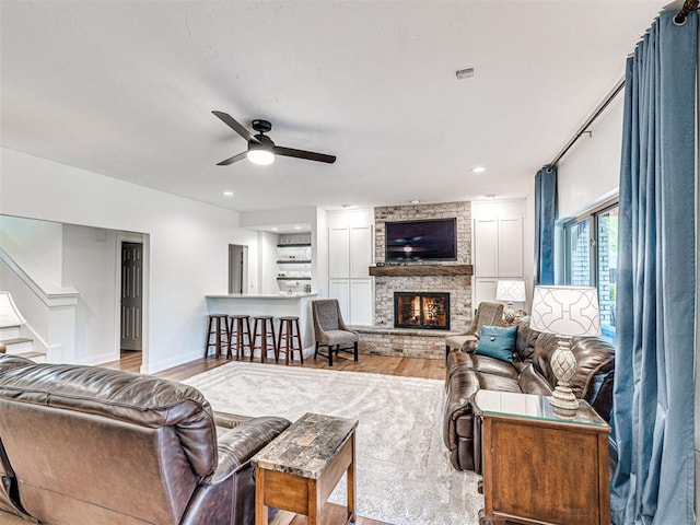 4238 Brookview, Norman, OK 73072 - living room with a ceiling fan, a stone fireplace, stairs, wood finished floors, and recessed lighting