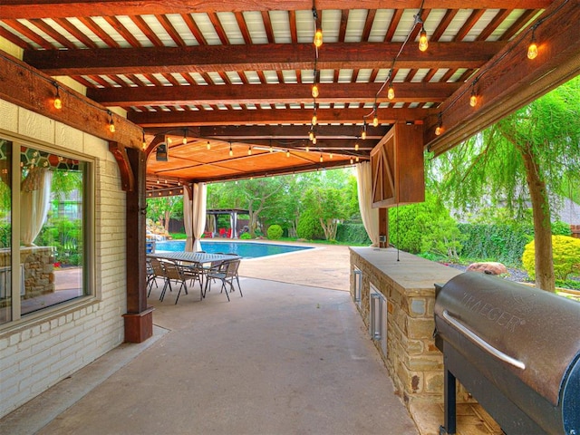 4238 Brookview, Norman, OK 73072 - view of patio featuring an outdoor kitchen, outdoor dining space, and an outdoor pool