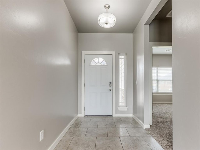 tiled entryway featuring baseboards