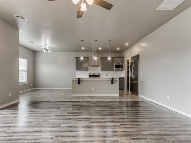 unfurnished living room featuring visible vents, baseboards, ceiling fan, recessed lighting, and light wood finished floors