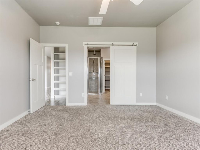 unfurnished bedroom with visible vents, carpet flooring, baseboards, and a ceiling fan