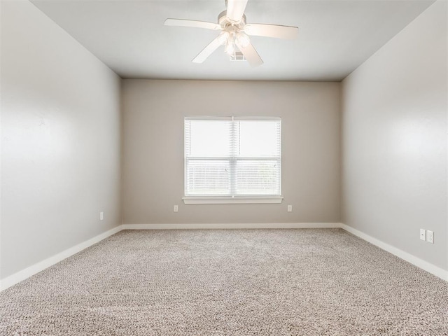 unfurnished room featuring baseboards, a ceiling fan, and carpet