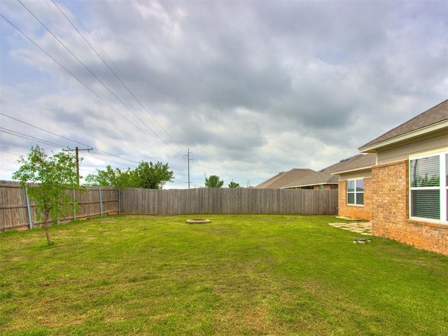 view of yard with a fenced backyard