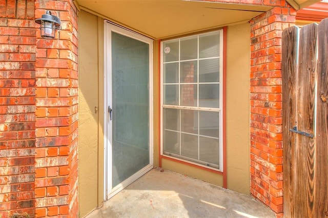 property entrance with brick siding