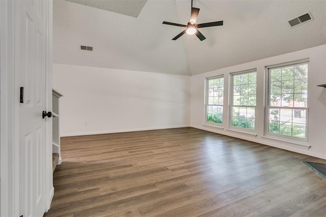empty room featuring visible vents, ceiling fan, and wood finished floors