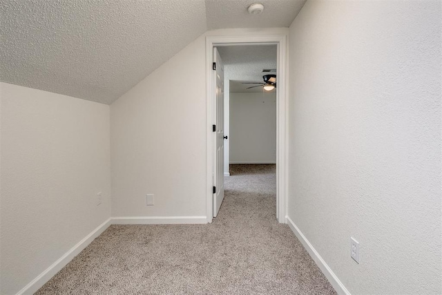 additional living space with lofted ceiling, baseboards, ceiling fan, a textured ceiling, and carpet flooring