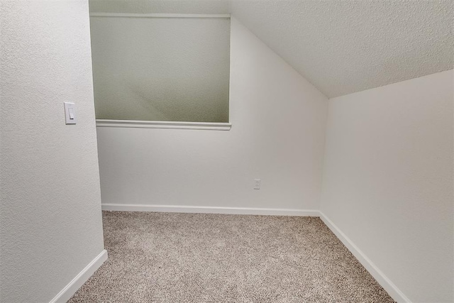 bonus room featuring carpet floors, baseboards, and vaulted ceiling