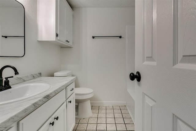 bathroom featuring vanity, tile patterned floors, baseboards, and toilet