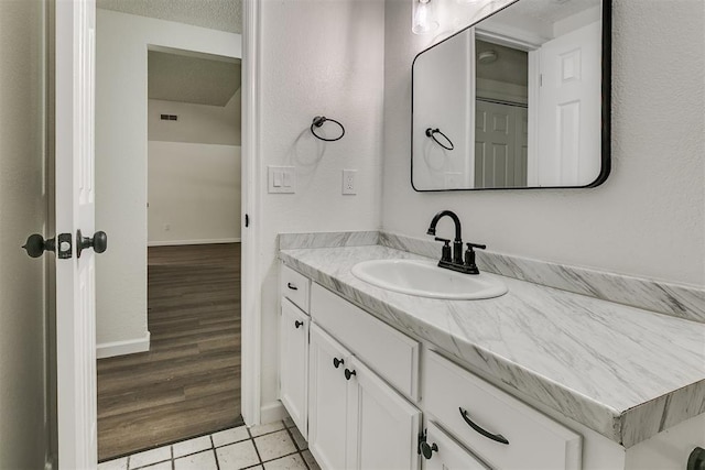 bathroom with vanity, baseboards, tile patterned flooring, and visible vents