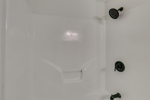 details featuring washtub / shower combination