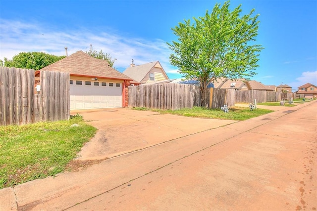exterior space with a garage and fence