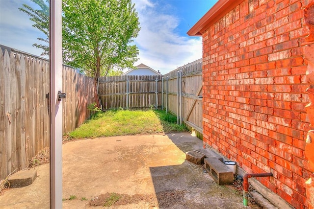 view of yard with a fenced backyard and a patio