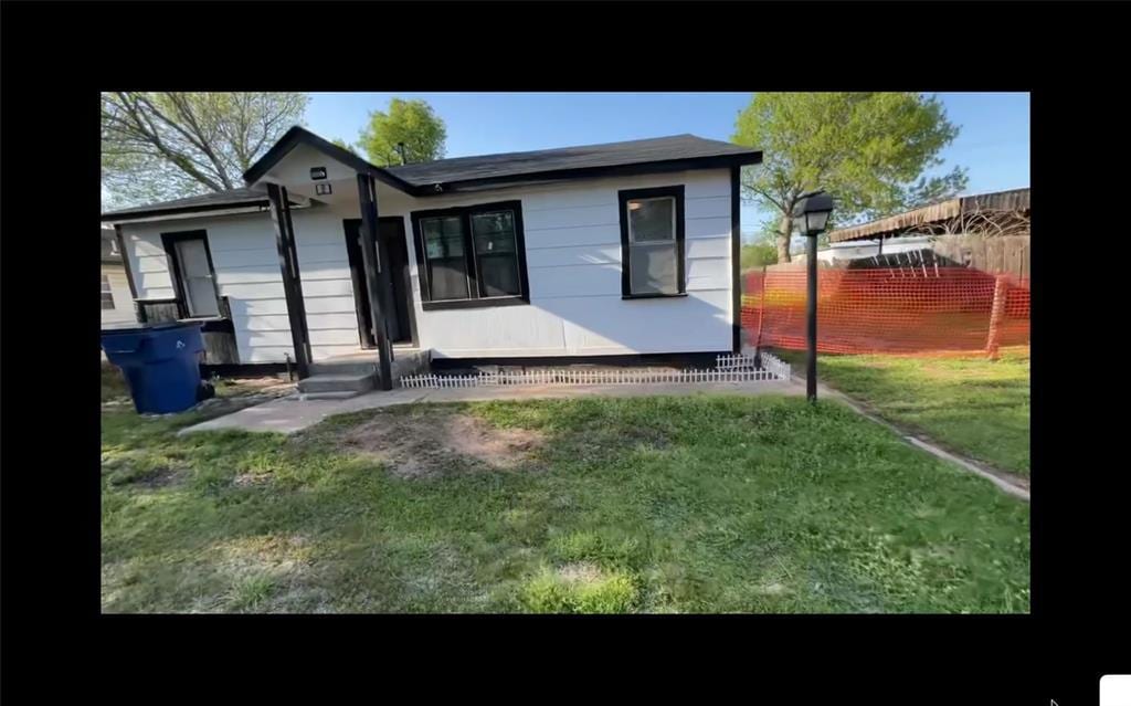 back of house featuring fence and a yard