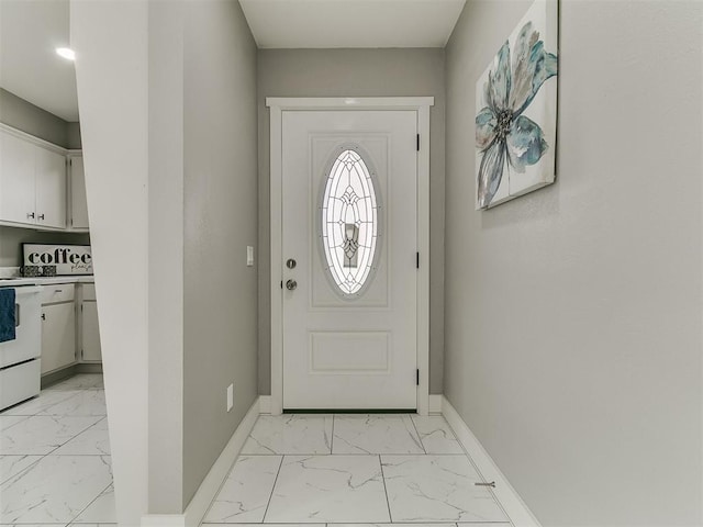 entryway with baseboards and marble finish floor