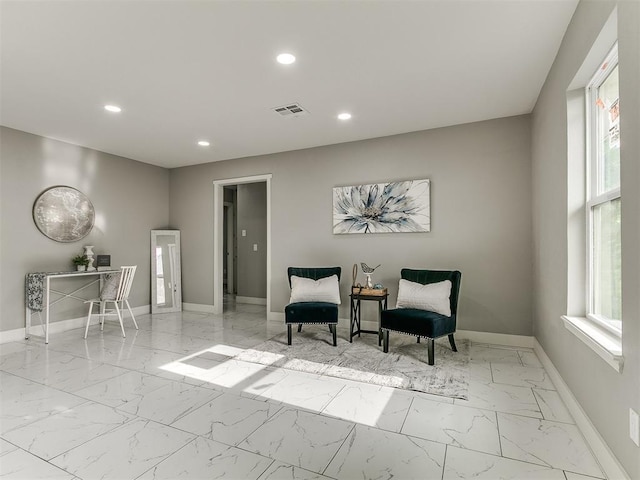 living area with visible vents, recessed lighting, marble finish floor, and baseboards