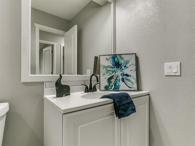 bathroom with vanity and toilet