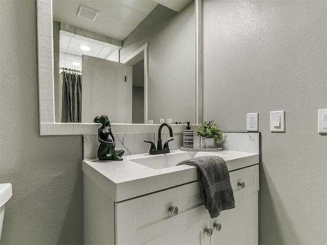 bathroom featuring vanity and visible vents
