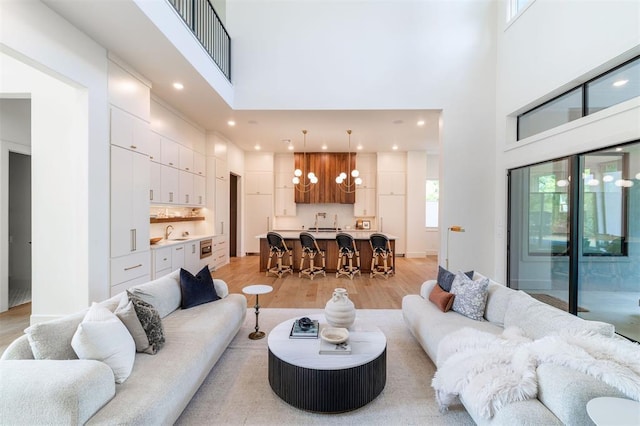 2826 Guilford Ln, Oklahoma City, OK 73120 - living area with a high ceiling, light wood-style floors, a chandelier, and recessed lighting
