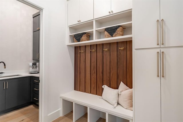 2826 Guilford Ln, Oklahoma City, OK 73120 - mudroom featuring a sink, light wood-type flooring, and baseboards
