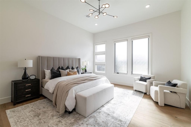 2826 Guilford Ln, Oklahoma City, OK 73120 - bedroom featuring a chandelier, wood finished floors, recessed lighting, and baseboards
