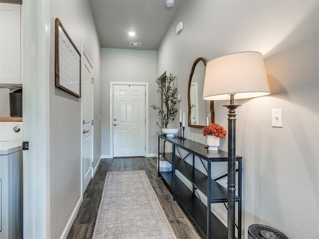 entryway with washer / clothes dryer, baseboards, visible vents, and dark wood-style floors