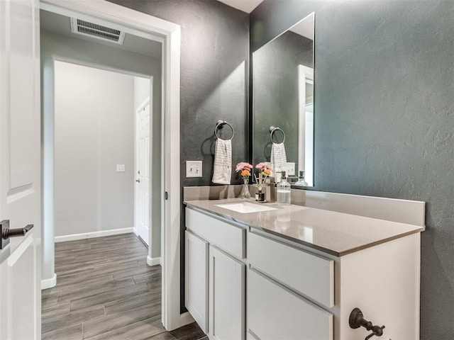 bathroom featuring visible vents, wood finished floors, and vanity