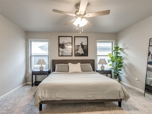 bedroom featuring baseboards, light carpet, and visible vents