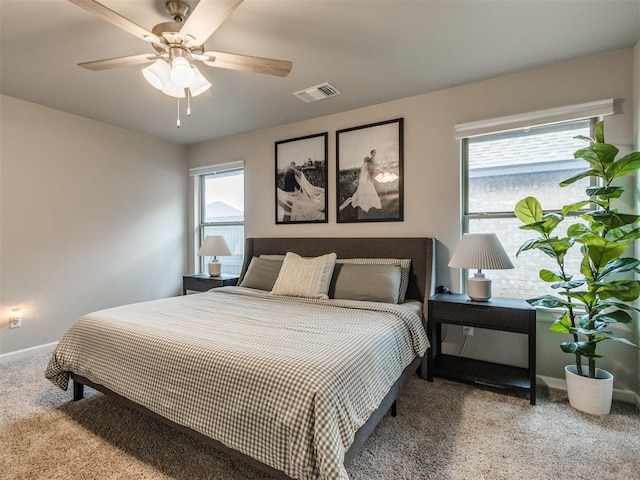 bedroom with carpet flooring, a ceiling fan, baseboards, and visible vents