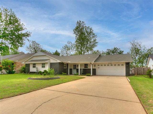 ranch-style home with fence, roof with shingles, a front lawn, a garage, and driveway