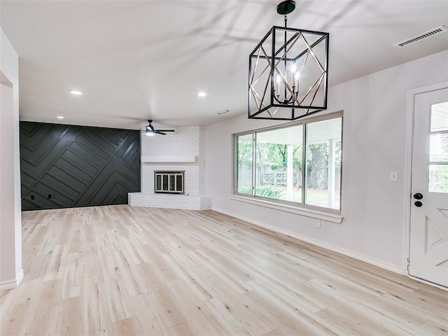 unfurnished living room with baseboards, plenty of natural light, and visible vents