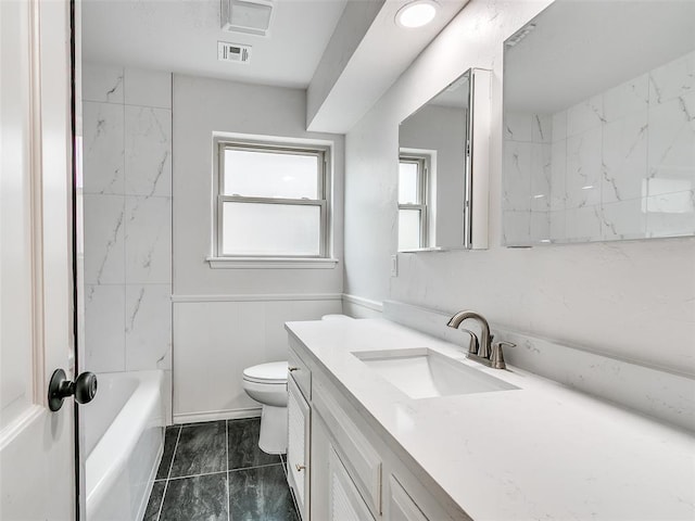 full bathroom with toilet, visible vents, a healthy amount of sunlight, and vanity