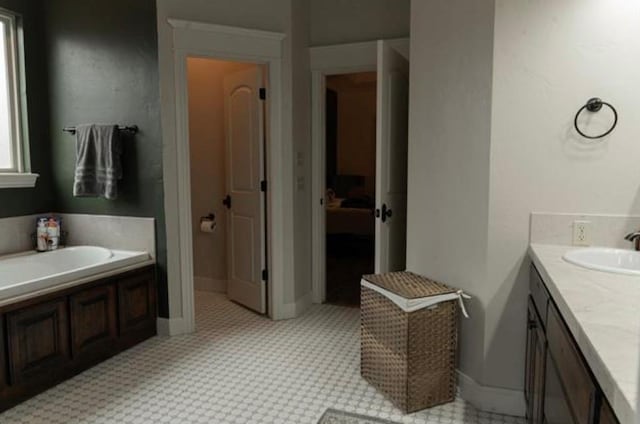 full bath with vanity and a bath