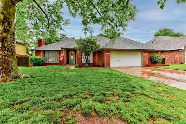 view of front of house with a garage, a front lawn, a chimney, brick siding, and concrete driveway