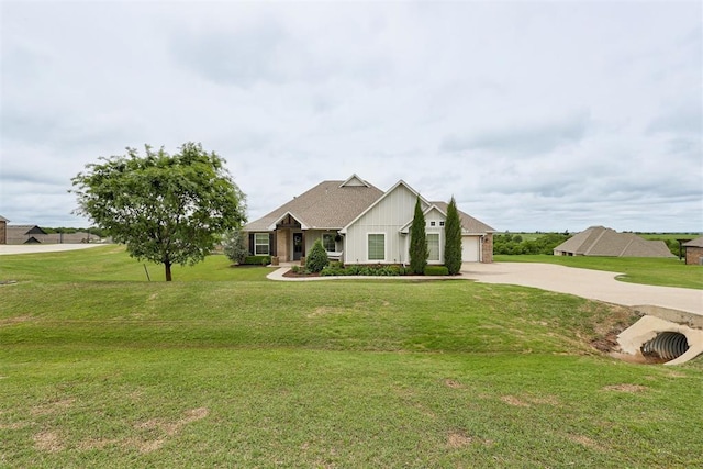 view of front of home with board and batten siding, driveway, a front yard, and a garage